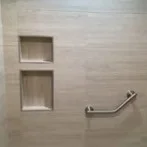 Shower with twin recessed niches and grab bar